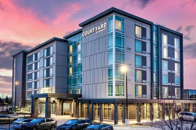 an office building with cars parked in a parking lot at Courtyard by Marriott Burlington-Oakville in Burlington