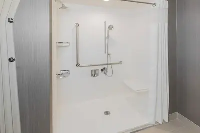 a shower with a glass door in a bathroom at Courtyard by Marriott Burlington-Oakville in Burlington