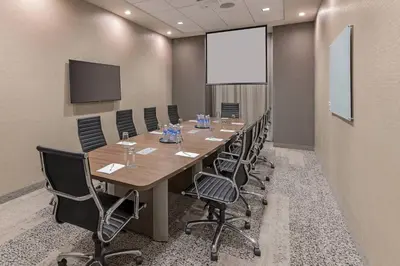 a conference room with a long table and chairs at Courtyard by Marriott Burlington-Oakville in Burlington