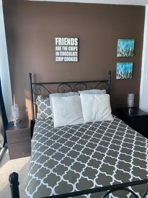 a bedroom with a bed with a black and white comforter at Stylish Condos Toronto in Toronto