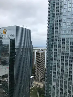 a tall building with a sign on the side of it at Stylish Condos Toronto in Toronto