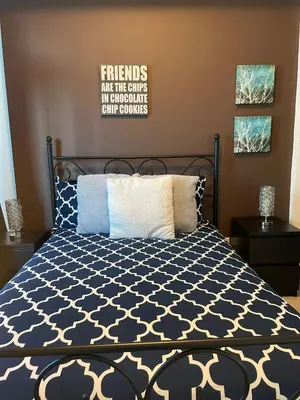 a bedroom with a bed with a black and white comforter at Stylish Condos Toronto in Toronto