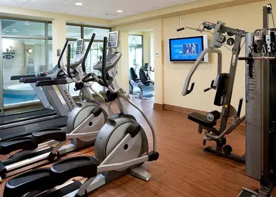 a gym with two treadmills and cardio machines at Waterfront Hotel Downtown Burlington in Burlington
