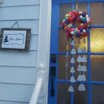 a door with a christmas wreath on it at Blue Spruce Bed and Breakfast Muskoka in Gravenhurst