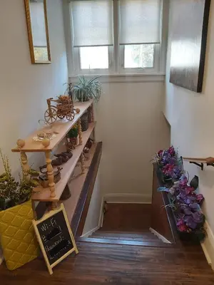 a room with a staircase with a table and some plants at Blue Spruce Bed and Breakfast Muskoka in Gravenhurst