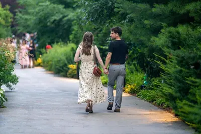 a man and a woman walking down a path at Staybridge Suites Hamilton - Downtown by IHG in Hamilton