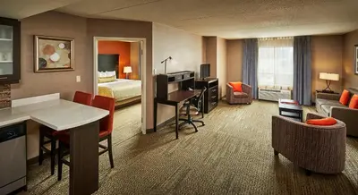 a hotel room with a living room with a hotel suite at Staybridge Suites Hamilton - Downtown by IHG in Hamilton