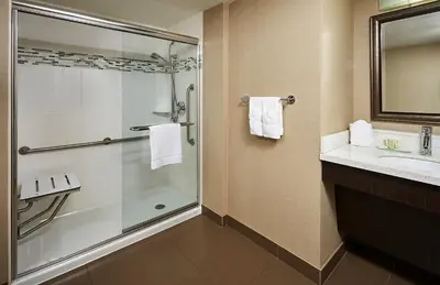 a bathroom with a shower and a sink at Staybridge Suites Hamilton - Downtown by IHG in Hamilton