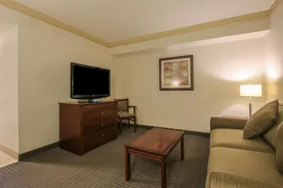a living room with a couch and a flat screen tv at Best Western Brantford Hotel and Conference Centre in Brantford