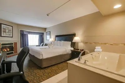 a hotel room with a bed and a bath tub at Best Western Brantford Hotel and Conference Centre in Brantford