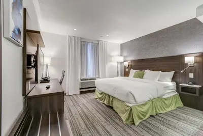 a hotel room with a large bed and a desk at EST Hotel in Toronto