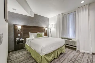 a hotel room with a large bed and a window at EST Hotel in Toronto