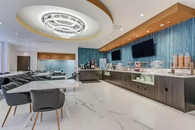a restaurant with tables and chairs and a tv at EST Hotel in Toronto