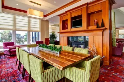 a dining room with a wooden table and chairs at Hilton Garden Inn Toronto/Markham in Thornhill