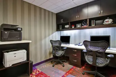 an office with two chairs and a desk with a computer at Hilton Garden Inn Toronto/Markham in Thornhill