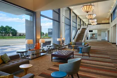 a lobby of a building with couches and chairs at Delta Hotels by Marriott Toronto Airport & Conference Centre in Toronto