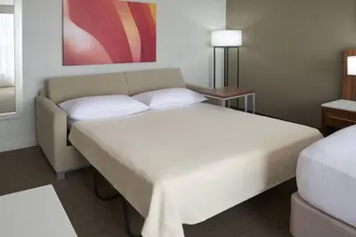 a hotel room with a bed and a table at Delta Hotels by Marriott Toronto Airport & Conference Centre in Toronto