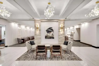 a lobby with chairs and a table and a painting at Homewood Suites by Hilton Toronto-Markham in Markham