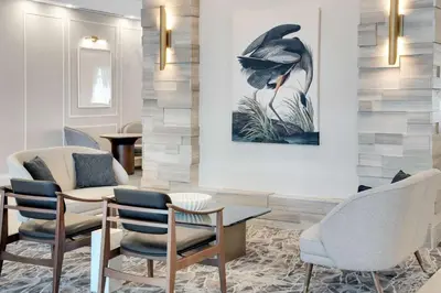 a lobby with chairs and a table and a painting on the wall at Homewood Suites by Hilton Toronto-Markham in Markham