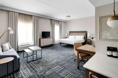 a hotel room with a bed and a couch at Homewood Suites by Hilton Toronto-Markham in Markham