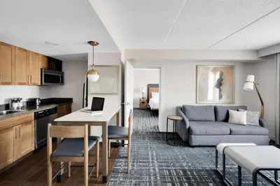 a kitchen and living room with a couch and a table at Homewood Suites by Hilton Toronto-Markham in Markham