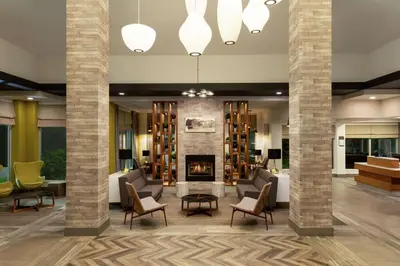 a lobby with chairs and a fireplace at Hilton Garden Inn Kitchener/Cambridge in Cambridge