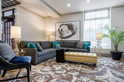 a living room with a couch and a chair at The Champlain Waterfront Hotel, an Ascend Collection Hotel in Orillia