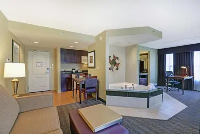 a living room with a tub and a kitchen at Homewood Suites by Hilton Cambridge-Waterloo, Ontario in Cambridge