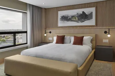 a bedroom with a large bed and a window at Hilton Toronto Airport Hotel & Suites in Mississauga