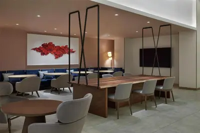 a dining room with a table and chairs at Hilton Toronto Airport Hotel & Suites in Mississauga
