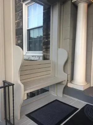 a porch with a bench and a window at Pring Guesthouse in Hamilton