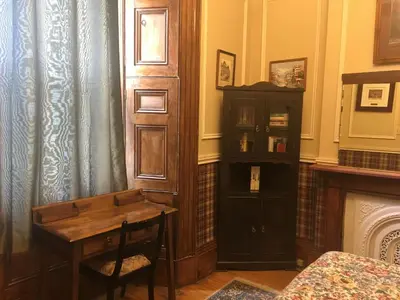 a room with a wooden desk and a book shelf at Pring Guesthouse in Hamilton