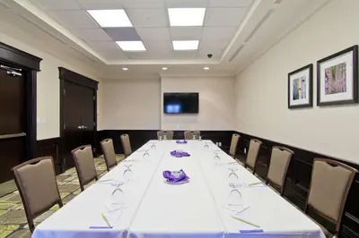 a conference room with a long table and chairs at Hilton Garden Inn Toronto/Ajax in Ajax