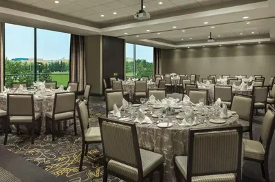 a banquet room with tables and chairs and a large window at Hilton Suites Toronto-Markham Conference Centre & Spa in Markham