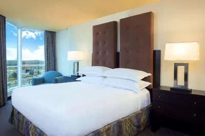 a large bed in a hotel room with a large window at Hilton Suites Toronto-Markham Conference Centre & Spa in Markham