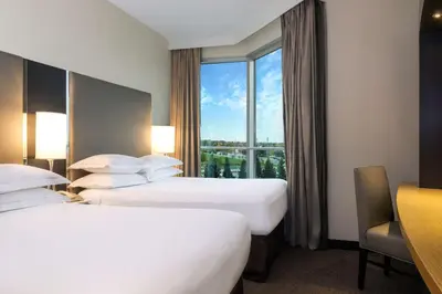 a hotel room with two beds and a window at Hilton Suites Toronto-Markham Conference Centre & Spa in Markham