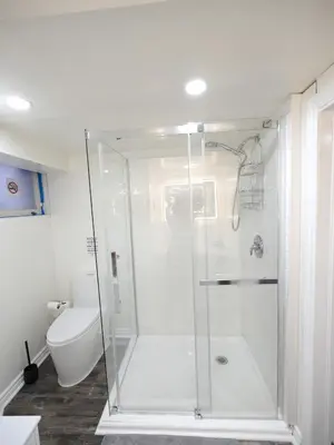 a bathroom with a shower and a toilet at Serene Niagara Inn in Niagara Falls