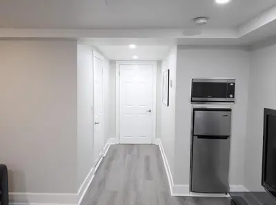 a kitchen with a refrigerator and a microwave at Serene Niagara Inn in Niagara Falls