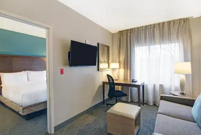 a hotel room with a bed and a desk at Staybridge Suites Toronto - Vaughan South by IHG in Vaughan