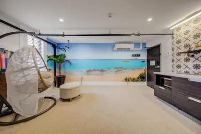 a living room with a painting of a beach at The Westlake in Toronto