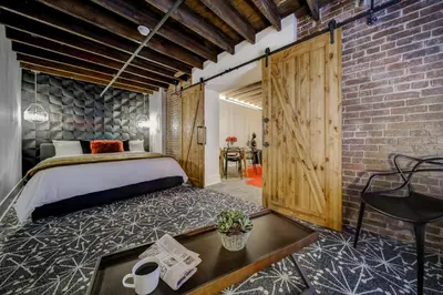 a bedroom with a bed and a brick wall at The Westlake in Toronto