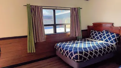 a bedroom with a bed and a window at Crestwood Motel in Burlington