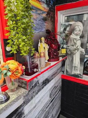 a shelf with figurines and a statue on it at Crestwood Motel in Burlington