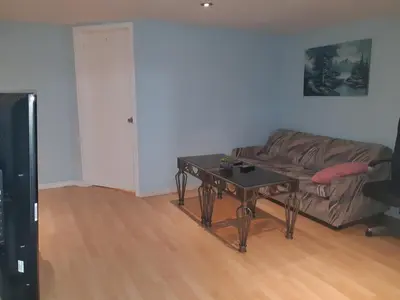 a living room with a couch and a table at McMaster Accommodations in Hamilton