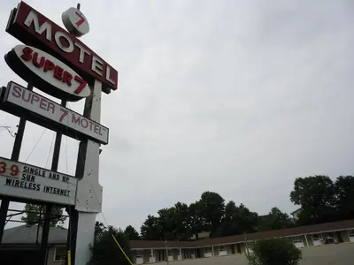 a sign for a super ninth motel in front of a building at Super 7 Motel London in London