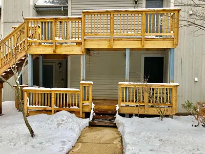 a wooden deck on a house in the snow at Blue Mountain Getaway at North Creek Resort King Bed in Blue Mountains