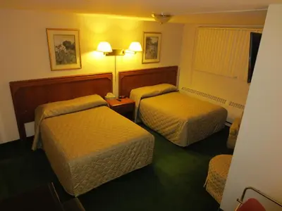 a hotel room with two beds and a window at Canadiana Motel in Hanover