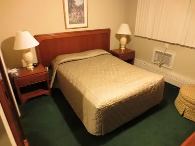 a hotel room with a bed and two night stands at Canadiana Motel in Hanover