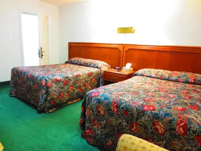 a hotel room with two beds and a table at Canadiana Motel in Hanover