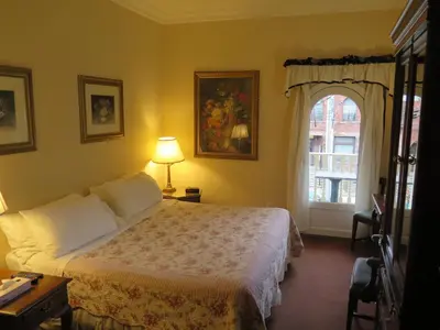 a hotel room with a bed and a window at Madison Manor Boutique Hotel in Toronto